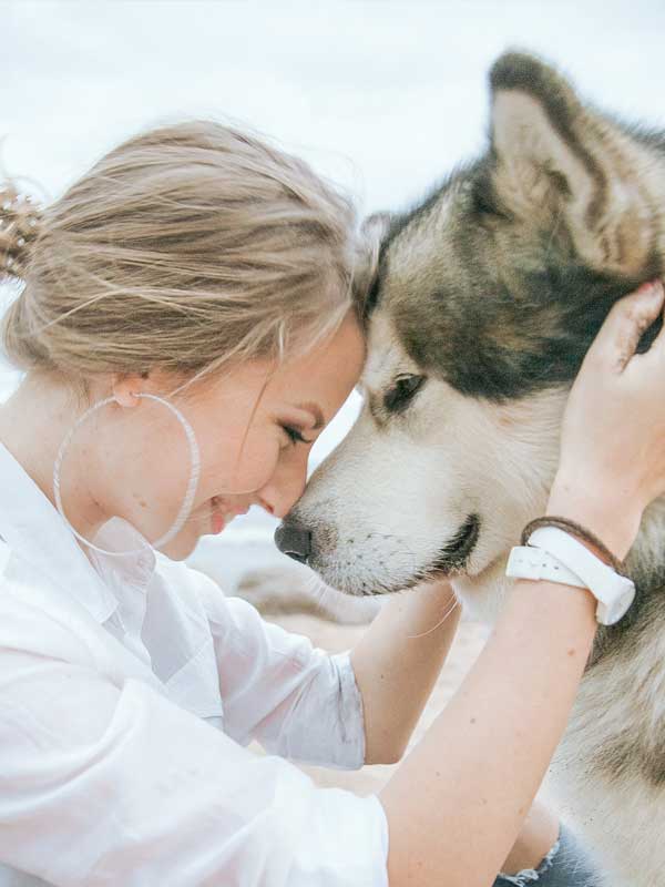 Lady face to face with malamute dog